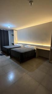 a room with two beds in a room with lights at Hotel SP in Belém