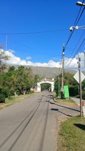 an empty road with a bridge in the distance at Siempre verde3 in Merlo