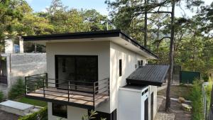 a small house with a balcony and a deck at Villa 1991 in San Ignacio