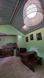 a large room with a table and a light at Villa Arkhazio in Megamendung