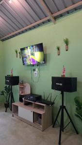 a room with a flat screen tv on a wall at Villa Arkhazio in Megamendung