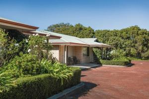 a house with a patio and bushes in front of it at Emu Point Motel in Albany
