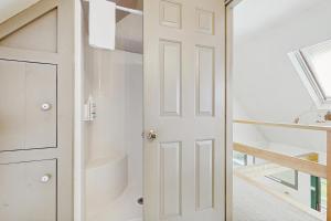 a white door in a room with a staircase at GOPI Notch in Franconia +41 photos