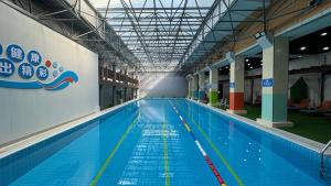 a large swimming pool in a large building at Jin Jiang West Capital International Hotel in Xi'an