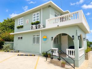 a house with a balcony on top of it at Playa y Campo Apartment #2 in Isabela