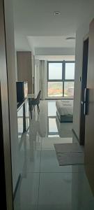 a white room with a bed and a desk and a chair at CondoApsara in Phnom Penh
