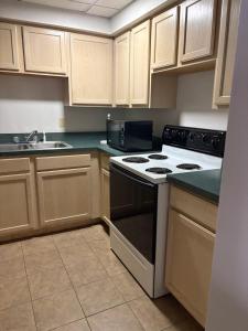 an empty kitchen with a stove and a sink at Comfort Suites Richmond in Richmond
