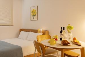 a small room with a bed and a table with food on it at Danchu stay in Seoul