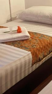 a bed with a comforter on top of it at Heritage House 123 in George Town +70 photos