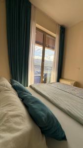 a bedroom with a bed with a large window at Harmonia Apart Hotel in Boreti