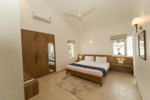 a bedroom with a large bed and a window at Azure Luxury 3-Bedroom Penthouse Candolim, Next to Novotel and Starbucks, close to Beach - By Lembranca in Candolim +51 photos