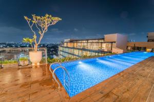 a swimming pool on the roof of a building at Altuz Apartment Seturan Yogyakarta in Seturan
