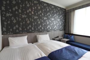 a bedroom with two beds and a wall with snowflakes at Hotel Castle Inn Tsu in Tsu +46 photos