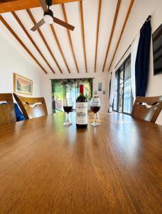 a bottle of wine sitting on top of a wooden table at Casa Fabiana in Lemos