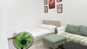 a room with a bed and a fan and a couch at 1932 OC2a in Nha Trang