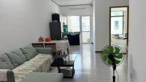 a living room with a couch and a table and a fan at 1932 OC2a in Nha Trang