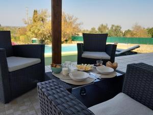 a table with bowls of food on a patio at AuraHouse Algarve in Lagoa