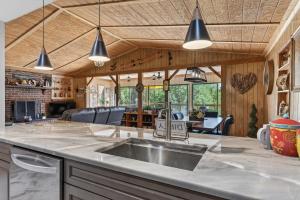a kitchen with a sink and a living room at Covea Cabin in Luray