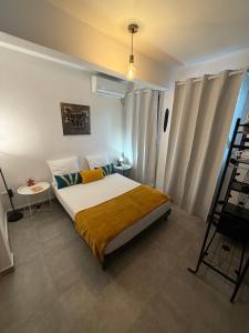 a bedroom with a bed and a table and a ladder at Chalet du Soleil in Pointe-Noire