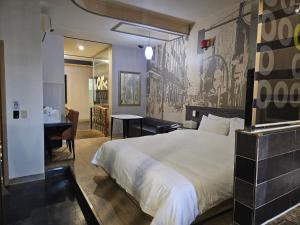 a hotel room with a bed and a desk and a table at Vov Hotel in Busan +138 photos