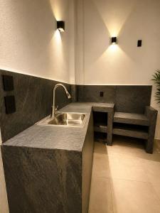 a kitchen with a sink and a bench and lights at Casa Luna con alberca privada y billar in Cuautla Morelos +9 photos