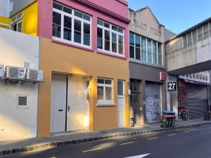 a row of buildings on a city street at Newton Lodge Auckland in Auckland