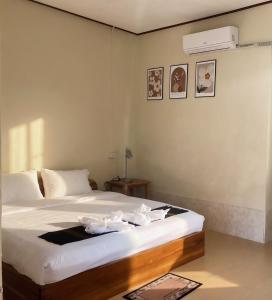 a bedroom with a bed with white sheets at XAIYASITH guesthouse in Nongkhiaw