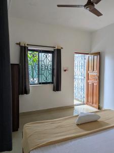 a bedroom with a bed and a window at shivkrupa Guest house in Arambol +11 photos