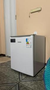 a refrigerator sitting on the floor next to a wall at cantinhoannajullyaatins in Atins
