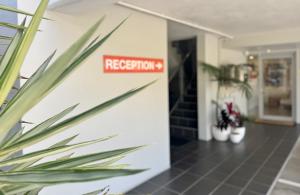 a sign on a wall that reads reception at Nambour Heights Motel in Nambour