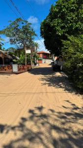 a dirt road with trees on the side of a street at cantinhoannajullyaatins in Atins +13 photos