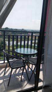 a table and two chairs on a balcony at Afa Homestay Melaka in Malacca
