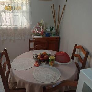a table with a bowl of fruit on it at T & H Oasis in Kingstown