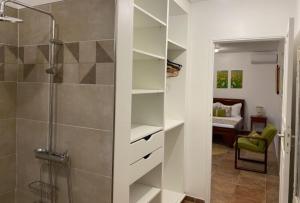 a bathroom with a shower and a walk in closet at La Marlyse in La Vatable