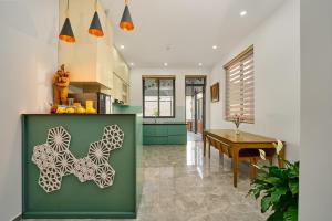 a kitchen and dining room with a butterfly painted on the wall at KP Villa Dalat in Da Lat +26 photos
