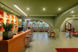 a library with a waiting area with tables and chairs at Nanxiang Shushan Hotel in Sanya