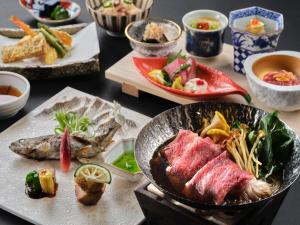 a table with a bowl of food and other dishes at La Vista Minami Aso Grand opening October 2nd 2026 in Minami Aso