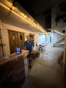 a man standing next to a counter in a building at Hotel Azulado - Como el mar in Jamundí