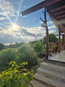 a porch with a view of a garden at Vaimoe Lodge à Rangiroa sur Tiputa in Tiputa +35 photos