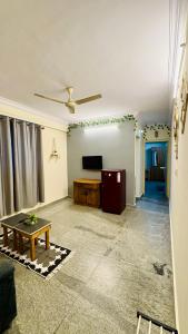 a living room with a tv and a table at Namma Suites 1BHK Serviced Apartment near NIMHANS & St Johns hospital in Bangalore