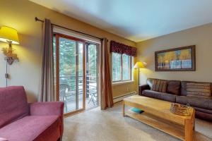 a living room with a couch and a table at Autumn Foliage 209 in Breckenridge