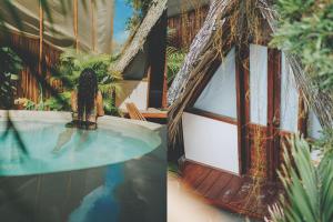 a resort with a swimming pool and a house at Casa Balam Holbox, Beach style cabañas in Holbox Island