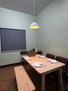 a conference room with a table and a projection screen at Chic Homestay Narathiwat in Ban Kam Pong Ba Ru