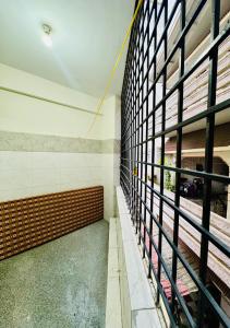 a hallway of a building with a wall of windows at Namma Suites 1BHK Serviced Apartment near NIMHANS & St Johns hospital in Bangalore