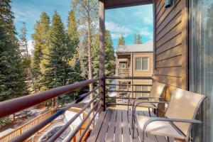 a balcony with chairs and a view of the woods at Year Round Getaway 301 in Breckenridge