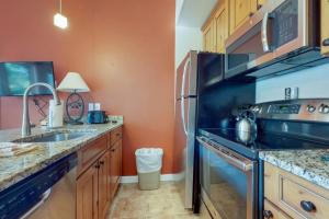 a kitchen with a stove and a sink and a refrigerator at Year Round Getaway 301 in Breckenridge +54 photos