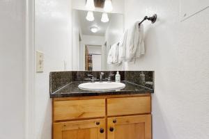 a bathroom with a sink and a mirror at On the Rapids - B Unit in Grand Lake +25 photos
