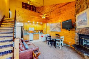 a living room with a couch and a table at Silver Lodge A & B in Granby