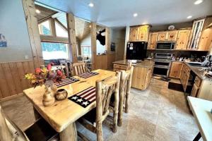 a large kitchen with a wooden table and chairs at Scenic Solitude in South Fork