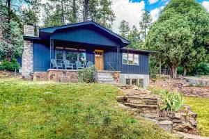 a blue house with a porch and a yard at Hermosa Hideaway in Durango